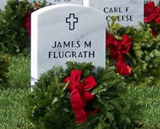 Small headstone with evergreen reef and red bow