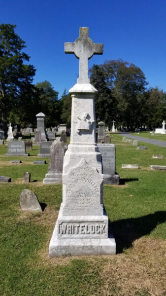 Large headstone with a cross on top