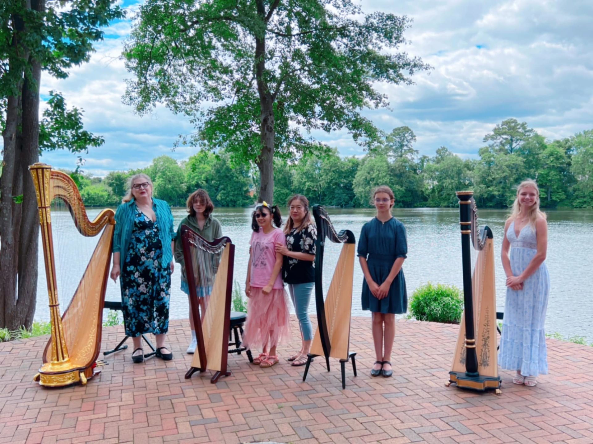 six girls standing beside harps at the Parsons Cemetery